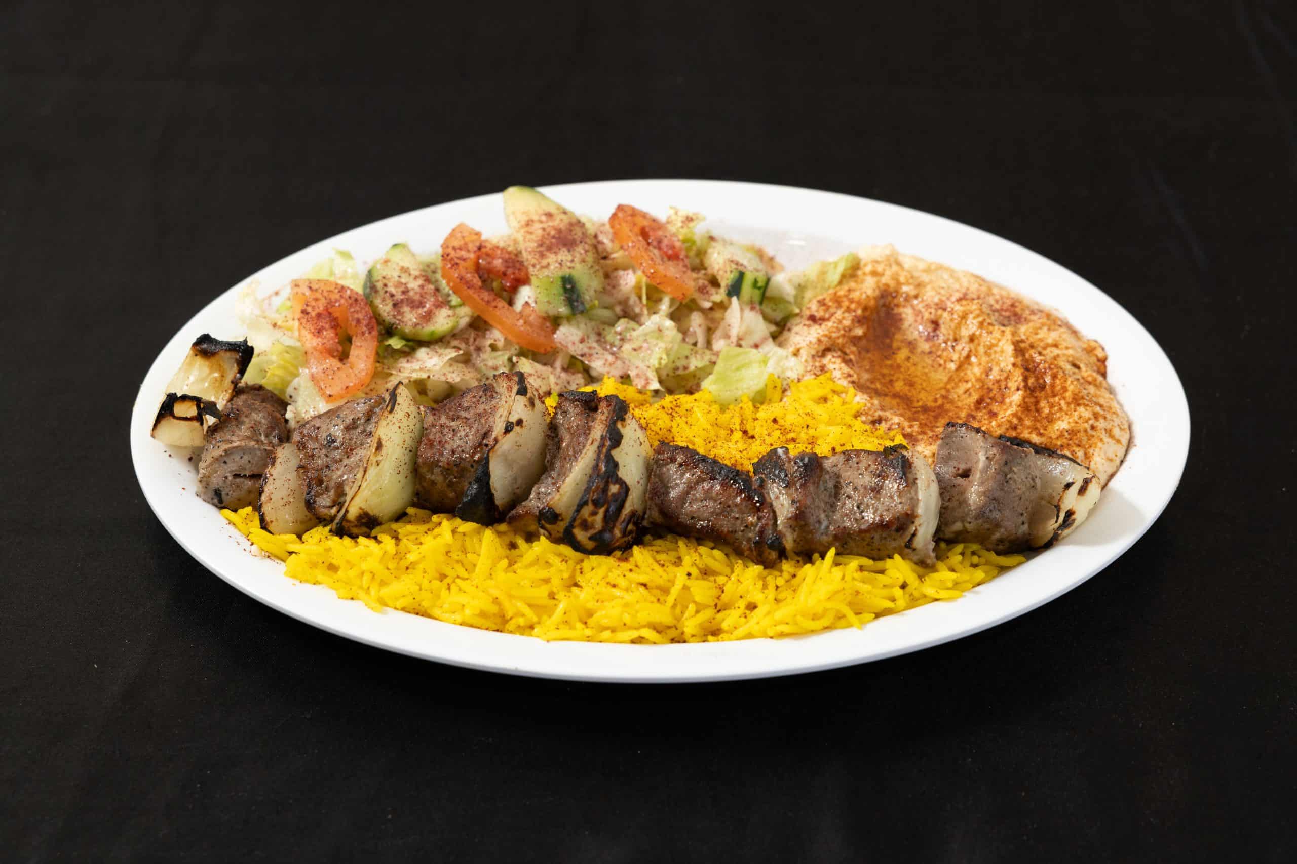 Beef Kebab Plate at Shawarma House SD — open-flame grilled halal ground beef kebab over saffron basmati with garden salad, hummus, pita, and toum — Ocean Beach, San Diego