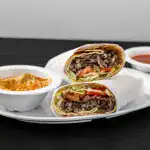 Beef Shawarma Pita Wrap at Shawarma House SD — premium beef shawarma spit-roasted and hand-shaved into warm pita with cr