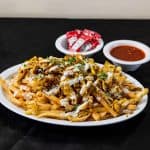Chicken Shawarma Fries at Shawarma House SD — crispy seasoned fries loaded with halal chicken shawarma, salad, and sauce
