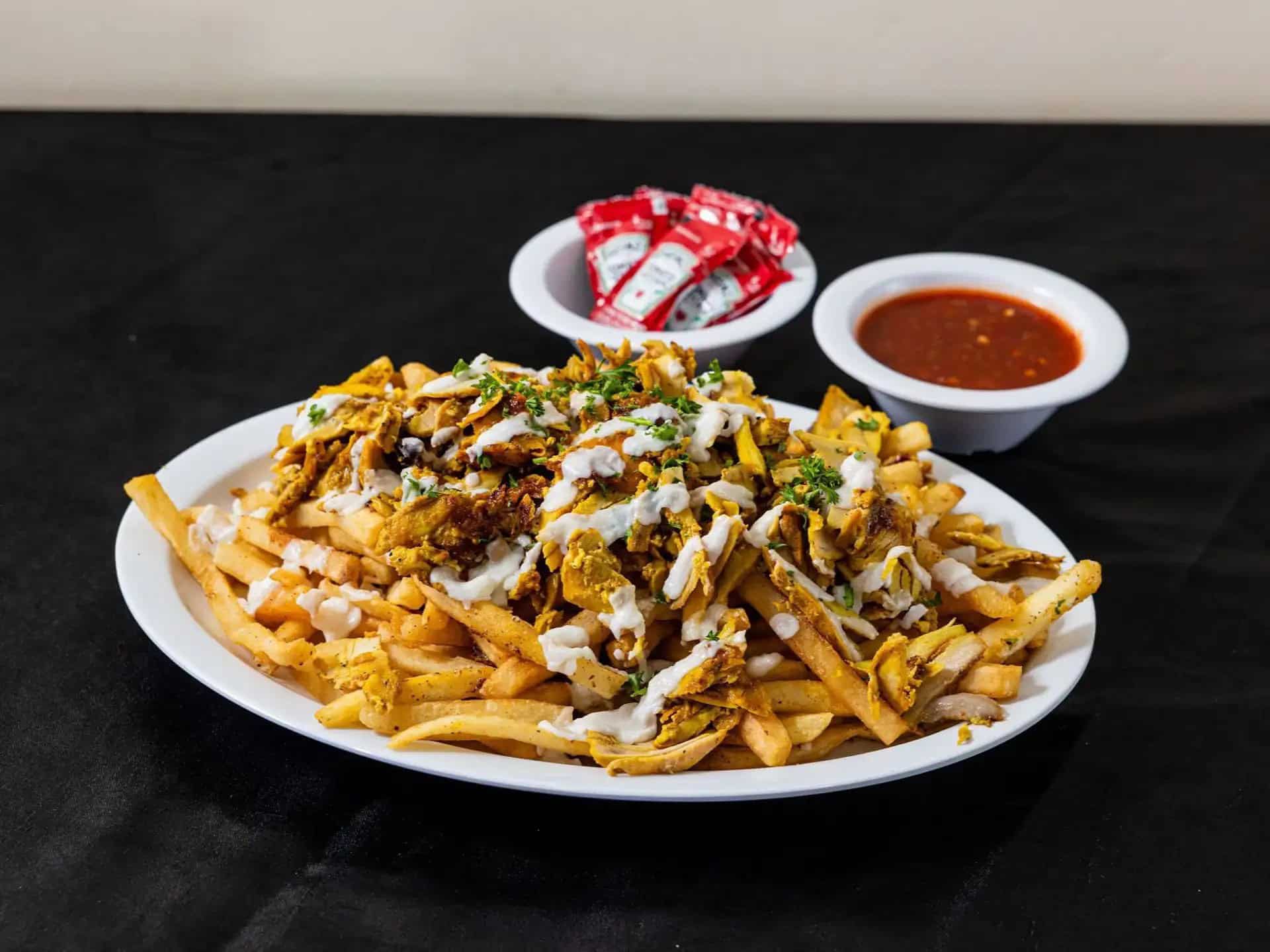 Chicken Shawarma Fries at Shawarma House SD — crispy seasoned fries loaded with halal chicken shawarma, salad, and sauces — Iraqi-Mediterranean in Ocean Beach