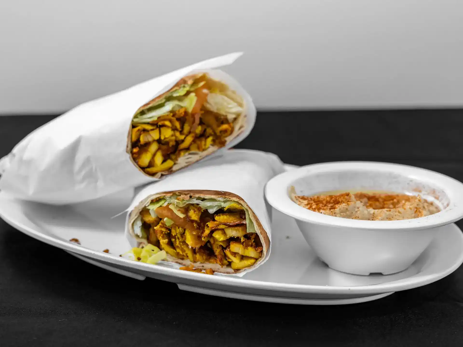 Chicken Shawarma Pita Wrap at Shawarma House SD — halal chicken shawarma marinated in baharat and sumac, hand-shaved into warm pita with salad, hummus, and toum — Ocean Beach, San Diego