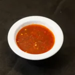 Chili Sauce at Shawarma House SD — house Iraqi-style hot sauce, vinegar-forward and garlic-bright with slow-build heat,