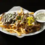 Combo Fries at Shawarma House SD — crispy seasoned fries loaded with all three spit proteins (beef shawarma, chicken sha