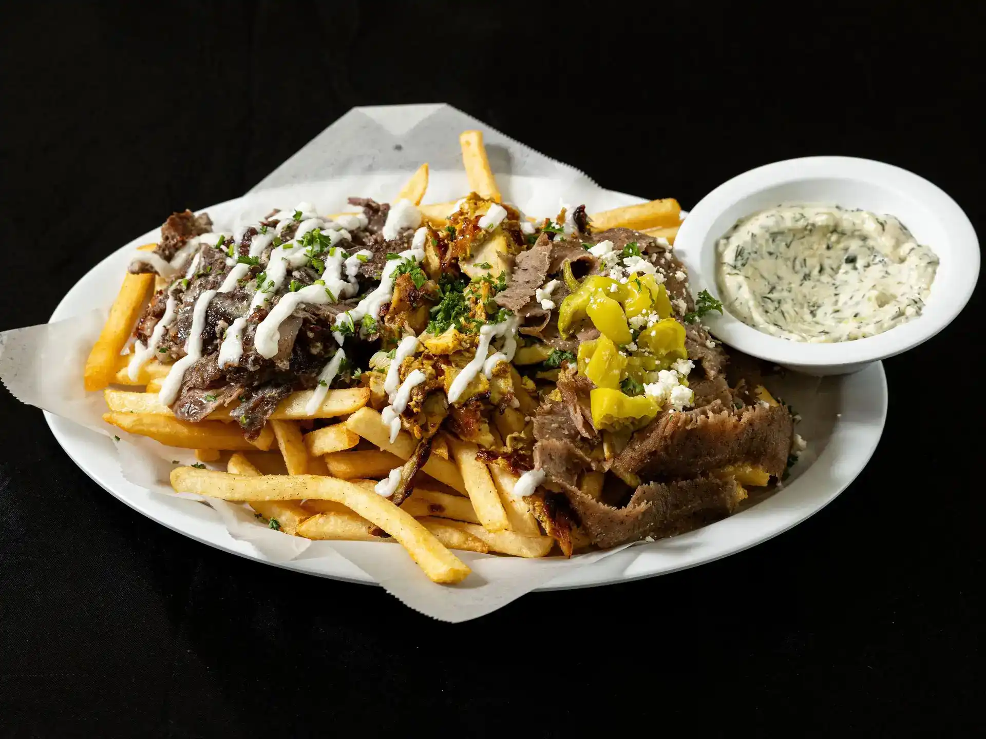 Combo Fries at Shawarma House SD — crispy seasoned fries loaded with all three spit proteins (beef shawarma, chicken shawarma, gyro) and salad — Ocean Beach, San Diego