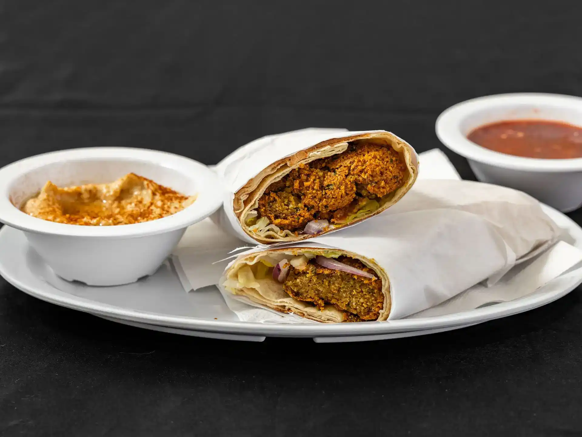 Falafel Pita Wrap at Shawarma House SD — hand-formed chickpea falafel fried to order in warm pita with salad, hummus, and tahini — 100% vegan Mediterranean in Ocean Beach