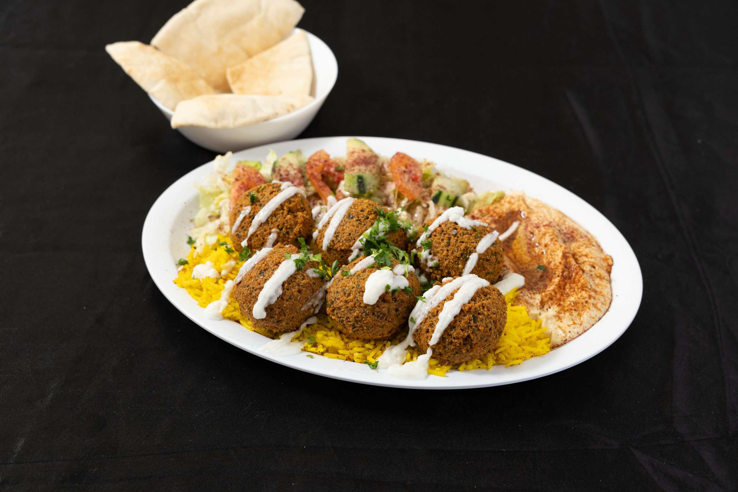 Falafel Plate at Shawarma House SD — hand-formed chickpea falafel fried to order over saffron basmati with salad, fresh hummus, warm pita, and tahini — 100% vegan in Ocean Beach, San Diego