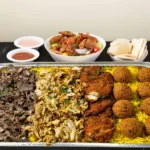 Family Tray at Shawarma House SD — Iraqi-Mediterranean catering combo of slow-roasted beef shawarma, hand-shaved chicken