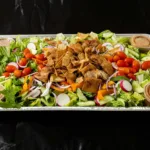Fattoush Salad Tray at Shawarma House SD — Levantine catering tray of romaine, herbs, sumac, and crispy pita chips with