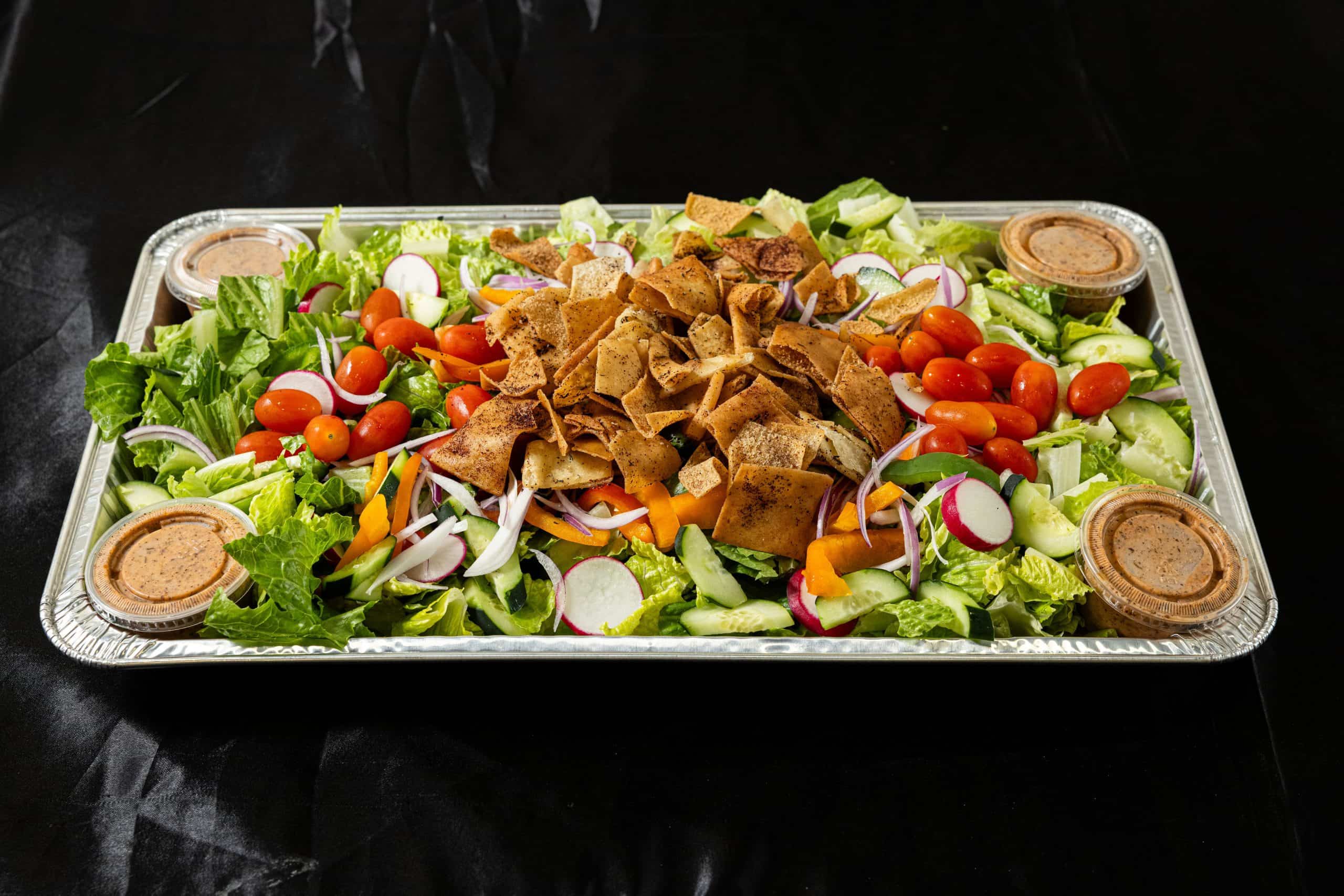 Fattoush Salad Tray at Shawarma House SD — Levantine catering tray of romaine, herbs, sumac, and crispy pita chips with house fattoush dressing — vegan Mediterranean catering in San Diego