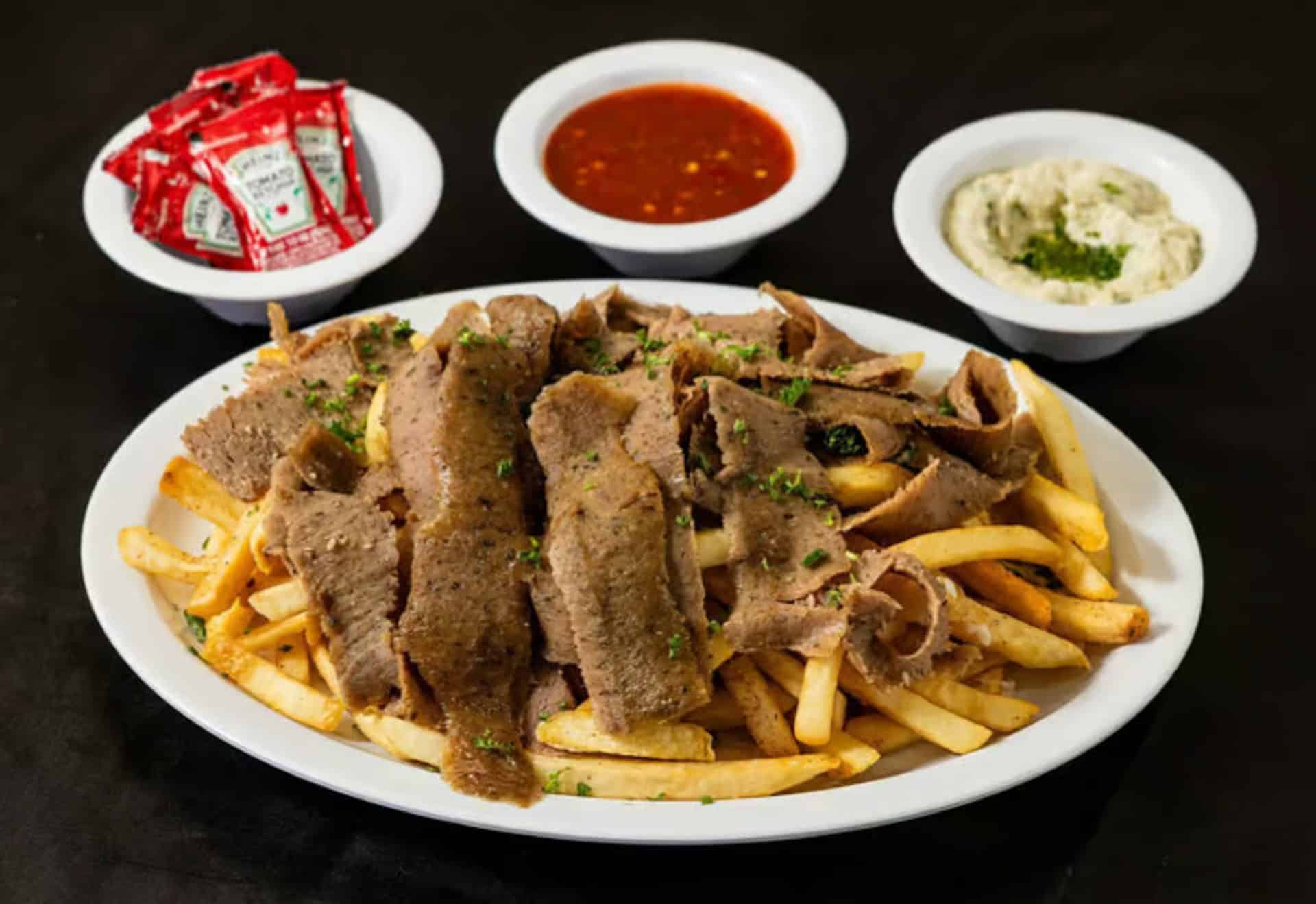 Gyro Fries at Shawarma House SD — crispy seasoned fries loaded with classic gyro, house tzatziki, and crisp salad — Mediterranean restaurant in Ocean Beach