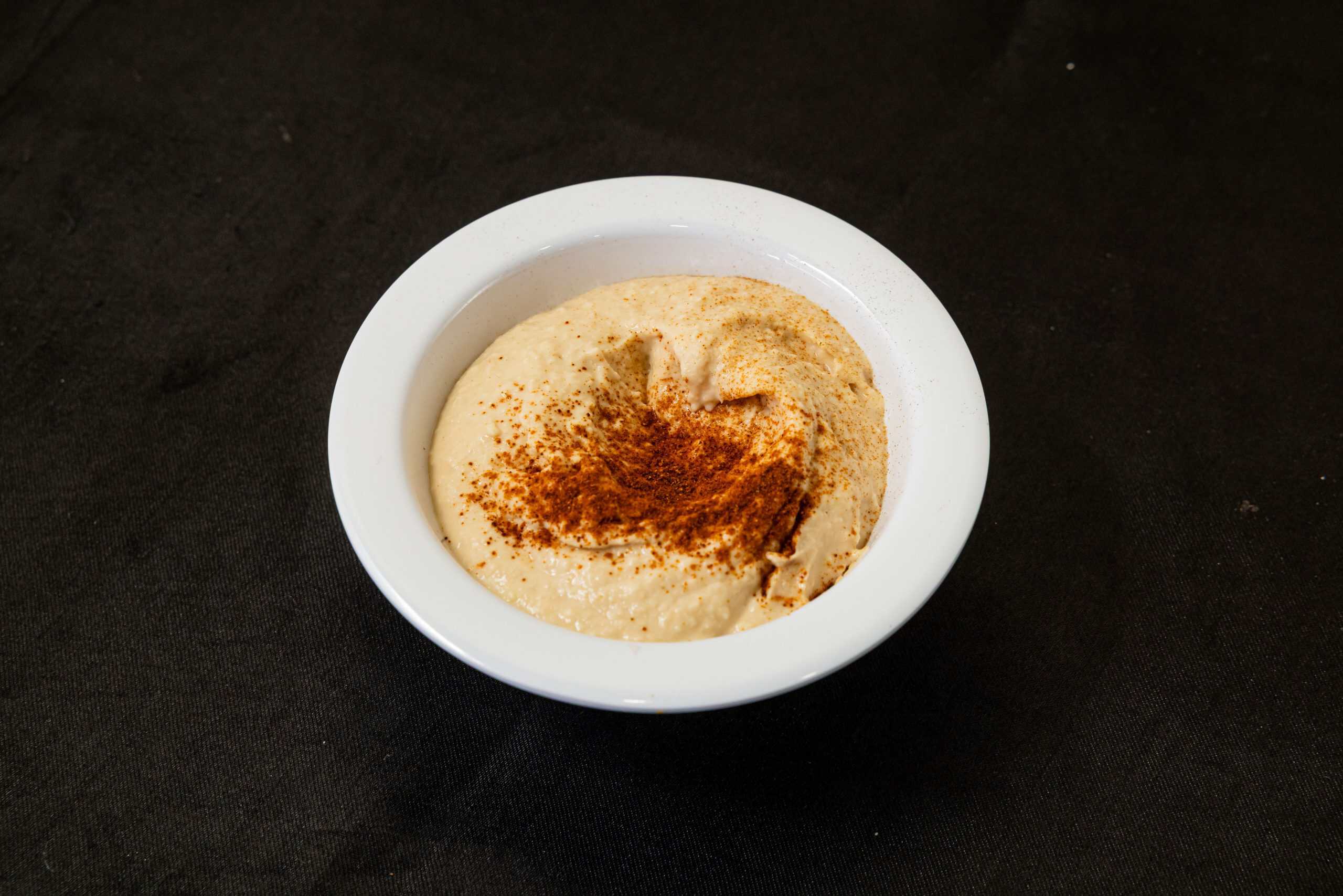 Hummus at Shawarma House SD — smooth garlicky chickpea-and-tahini hummus made fresh in-house with olive oil and paprika — vegan and gluten-free in Ocean Beach, San Diego