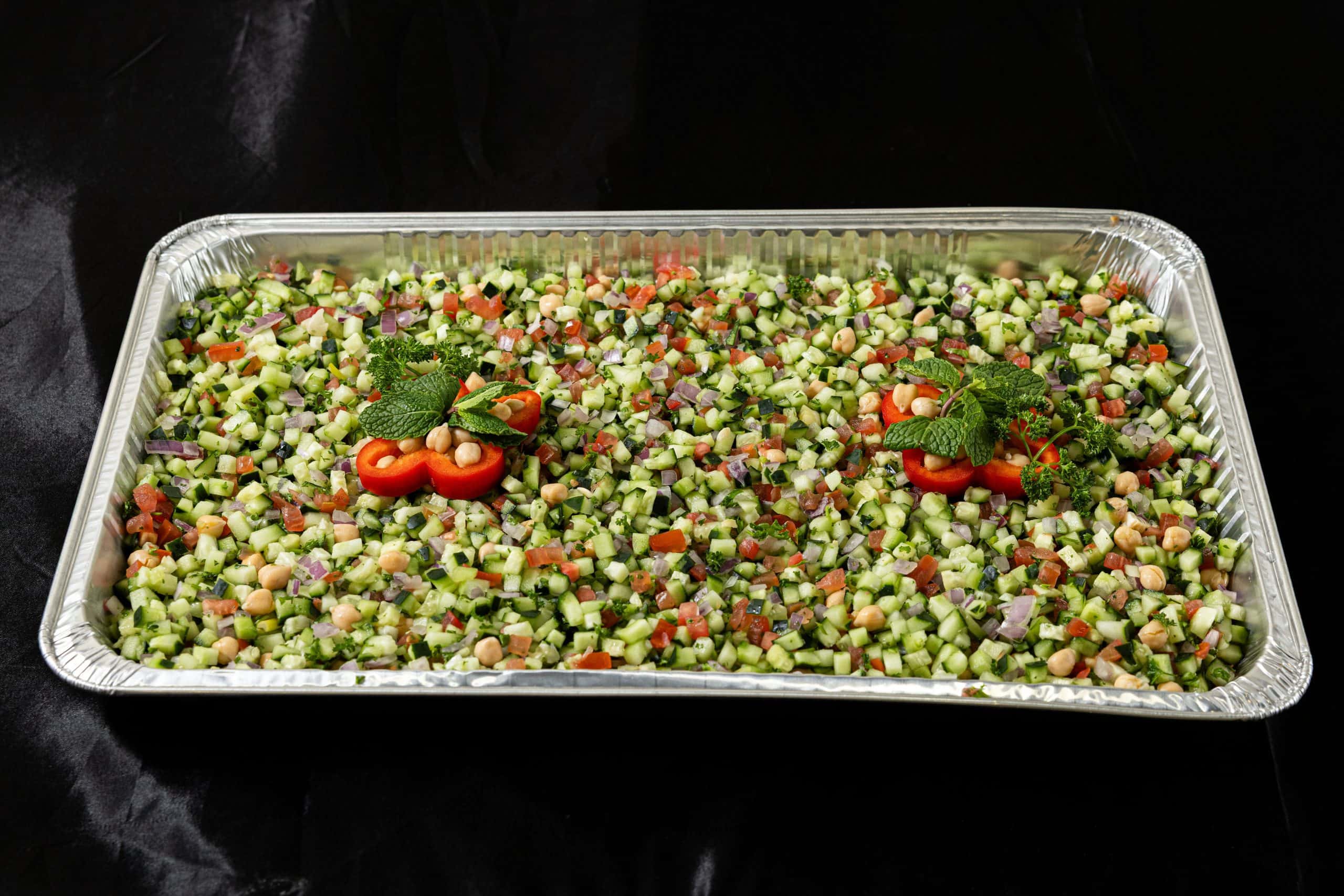 Iraqi Salad Tray at Shawarma House SD — catering tray of Iraqi-Mediterranean chopped salad with diced tomato, cucumber, herbs, and olive oil — vegan in San Diego