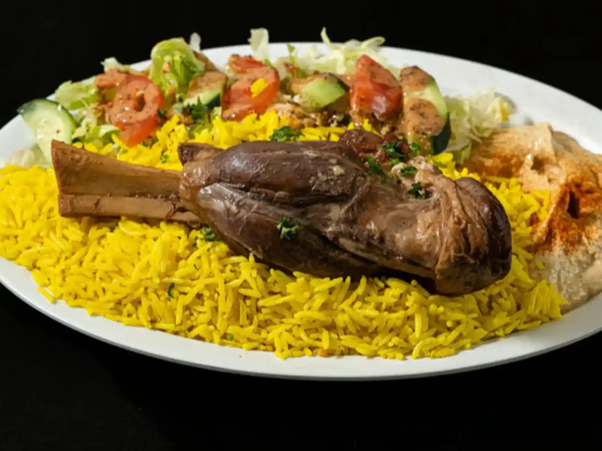 Lamb Shank Plate at Shawarma House SD — slow-braised halal lamb shank over saffron basmati with crisp salad, hummus, and warm pita — Iraqi-Mediterranean restaurant in Ocean Beach, San Diego