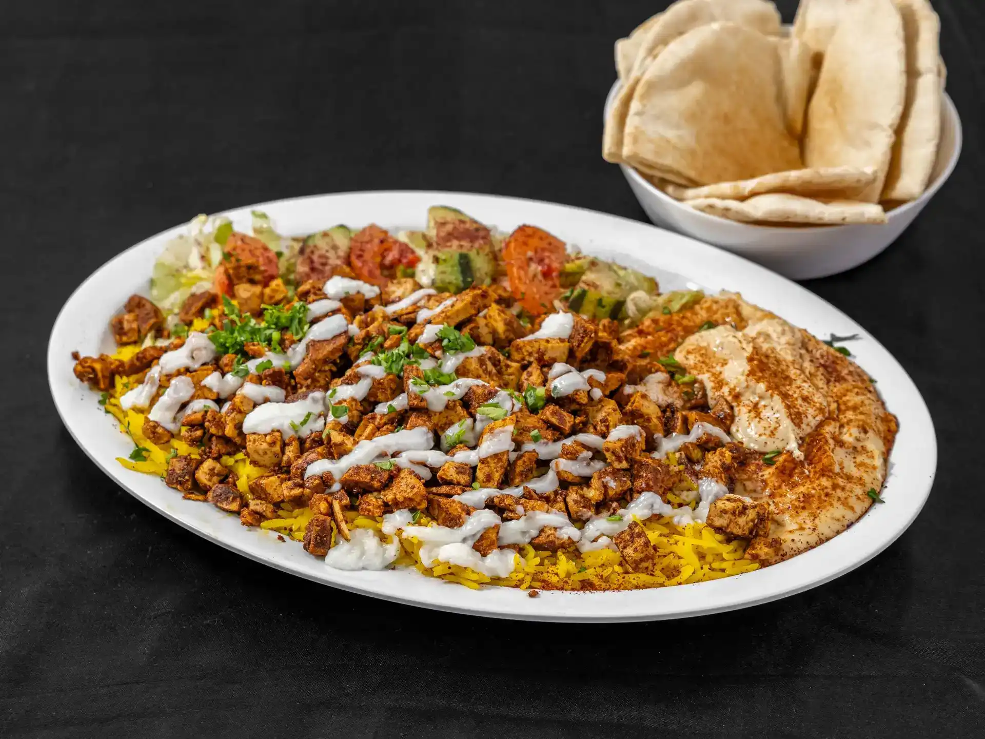 Vegan Shawarma Plate at Shawarma House SD — plant-based shawarma seasoned with baharat, sumac, and dried lime over saffron basmati with salad, hummus, pita, and toum — 100% vegan in Ocean Beach